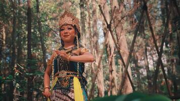 Graceful Javanese Female Dancer in a Golden Headdress Performing Outdoors video