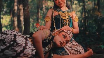 A Woman in Javanese Costume Comforting a Man in Her Lap video