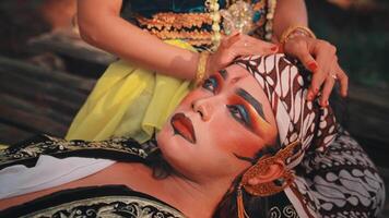 Intimate Close-Up of Javanese Performer Resting in Partner's Lap video