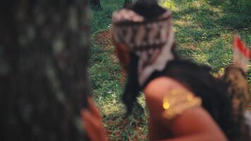 Rear View of a Javanese Archer Hiding Behind a Tree video