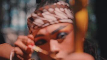 Javanese Archer with Intense Makeup Aiming a Bow video