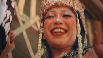 A dynamic and intimate close-up of a Javanese prince and princess character, laughing and interacting joyfully. The moving camera captures their happiness and the intricate details video