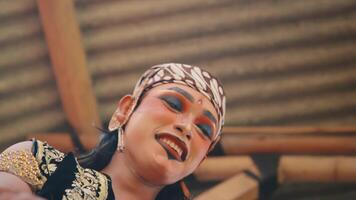 A dynamic and intimate close-up of a Javanese prince and princess character, laughing and interacting joyfully. The moving camera captures their happiness and the intricate video