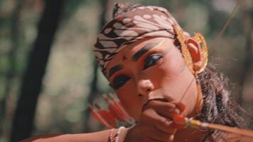 A Javanese Archer with Makeup Aims a Bow in the Forest video
