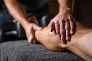 A man getting a massage on his leg photo