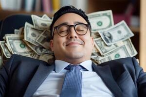 Man in business suit relaxing on chair with money surrounding him in a cozy office environment photo