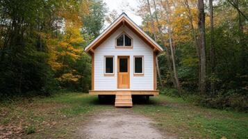 Cozy tiny house surrounded by vibrant autumn foliage in a serene wooded area photo