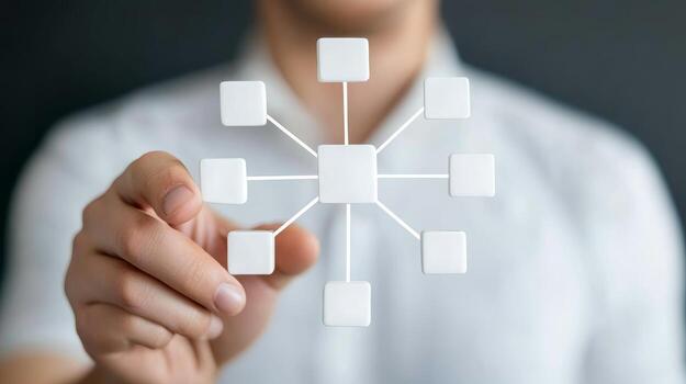 Person holding a complex flowchart design featuring blank white rectangles and lines against a dark background in an office setting photo