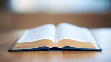 Open book with pages fanned on a wooden table, showcasing knowledge and literacy in a serene setting photo