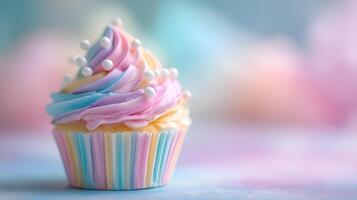 Delicious pastel colored cupcake decorated with icing and pearls on blurred background photo