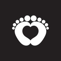 Baby footprints icon. baby feet icon on black background with heart shape. vector