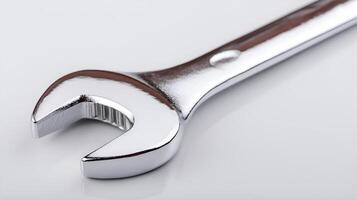 Chrome wrench lying on white background representing craftsmanship photo