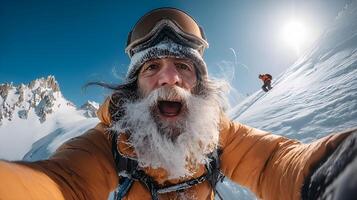 Excited snowboarder taking selfie on mountain top with frozen beard photo