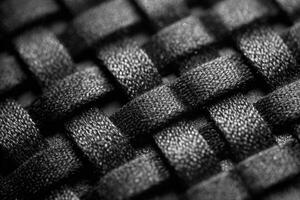 Intricate black and white macro view of woven fabric showcasing detailed textures and patterns photo