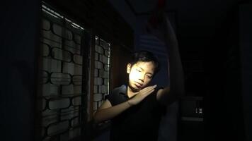 Person Using Flashlight to Look Through Window at Night video