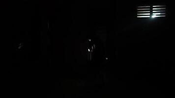 Silhouette in a Dark Room with Flashlight video