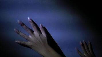 Hands Exploring a Textured Wall in Dim Light video
