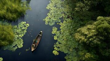 Fishermen navigating a serene river through lush lily pads photo
