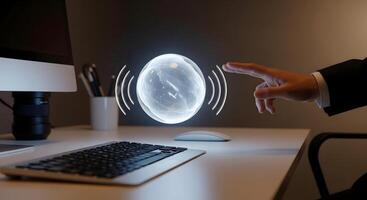 A person is touching a computer screen with a sphere on it photo