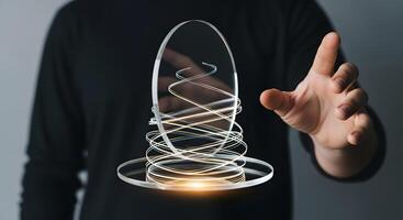 A person holding a glass sphere with a light coming out of it photo