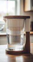 A water filter sitting on a wooden stand photo