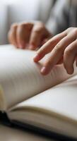 A person is holding a book with their hand photo