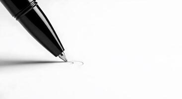 A black and white photo of a pen writing on a white surface