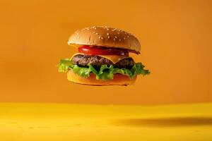 A hamburger is flying in the air on a yellow background photo