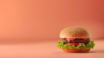 A hamburger is shown on a pink background photo