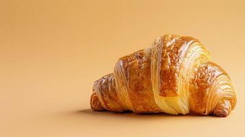 A croissant is shown on a yellow background photo