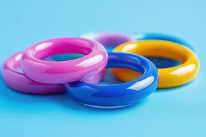 A pile of colorful rings on a blue surface photo