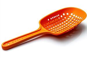 A plastic colander with an orange handle photo
