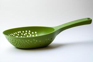 A colander with holes in it is green photo