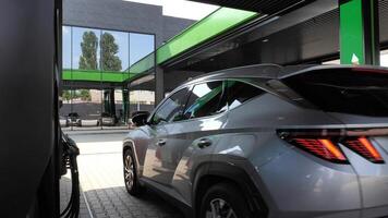 Vehicle near fuel column at a petrol station ready to refueling stock photo