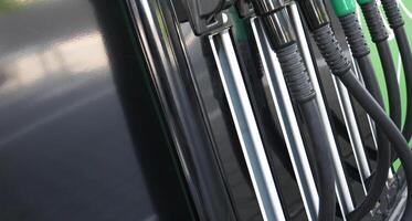 Hoses of filling nozzles for different types of fuel closeup view photo