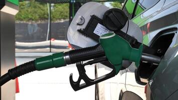 Opened Fuel Tank Hatch With Petrol Pistol In Filler Neck Closeup View Stock Photo