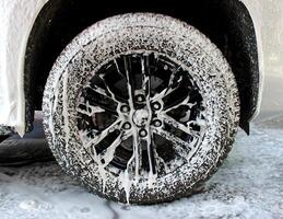 Detailed Photo Of Car Wheel Covered With Foam At Car Washing