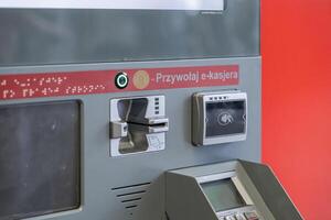 Modern automated payment terminal featuring contactless options, braille accessibility, and Przywolaj e-kasjera for inclusive public service photo