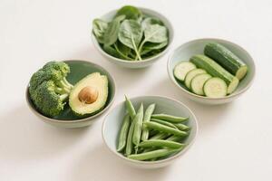 Seasonal vegetables in color-themed bowls, clean flat lay photo