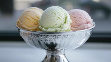 A silver bowl with three scoops of ice cream photo