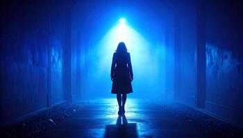 Lone Silhouette in a Foggy Tunnel Bathed in Mysterious Blue Light photo