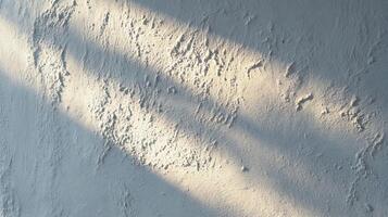 Rough white wall texture illuminated by warm sunlight and dark shadows. photo