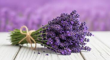 Fresh fragrant lavender bouquet on white wooden table with blurred background. photo