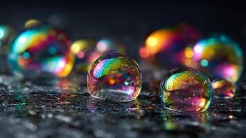 Vibrant soap bubbles reflecting a spectrum of colors on a dark surface. photo