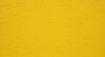 Bright yellow textured wall background, stucco plaster surface. Ideal for design projects. photo