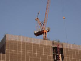 HighRise Construction Utilizing a Crane Actively Engaged in Work and Operations photo