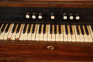 A beautifully designed Vintage Wooden Keyboard featuring both keys and stops for functionality photo