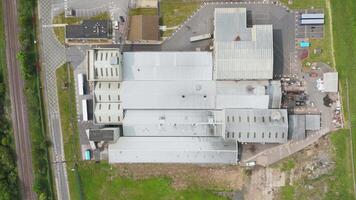 Expansive Drone Shot of Commercial Warehouses Next to River Trent with Renewable Wind Turbines and Power Plant in Rural Landscape video