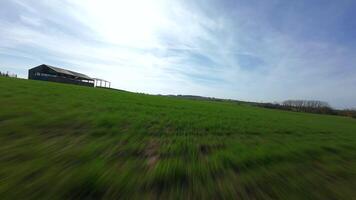 FPV drone shot following aqueduct and green fields in rural England video