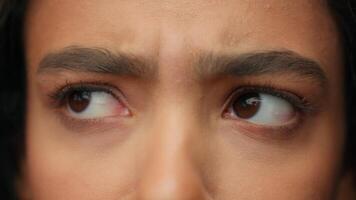 Close up human eyes Latina Hispanic girl woman beauty female face part details open eye dark eyeball looking at camera health medical care eyelid vision eyesight makeup eyelashes portrait gaze indoors video